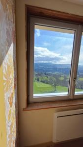 a window with a view of a green field at Passiflore in Saint-Racho +4 photos