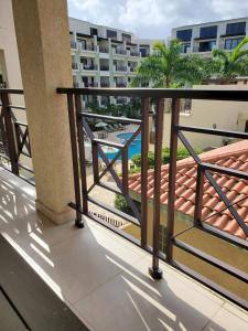a balcony with a view of a swimming pool at PALMARUBA 2bedroom condo in Palm-Eagle Beach