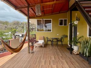 a hammock on the deck of a house at Departamento Raya in Puerto Ayora