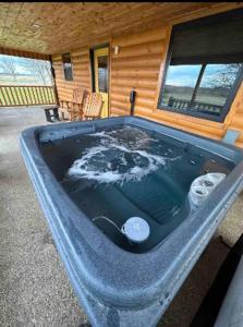 a large jacuzzi tub in the front of a house at Private Bourbon Cabin in Harrodsburg