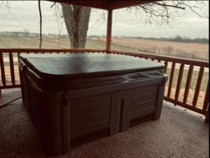 a hot tub sitting on top of a balcony at Private Bourbon Cabin in Harrodsburg