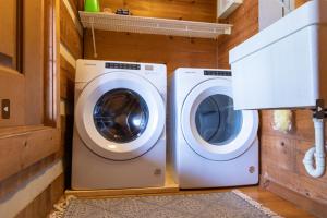a washing machine and a dryer in a laundry room at Governor's Private Cabin on Bourbon Trail w HotTub in Harrodsburg