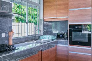 a kitchen with a sink and a window at 3BR Beachfront Villa Steps from the Lagoon in Paopao