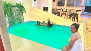 a group of women in a swimming pool at Hostal Maravilla Amazónica in Iquitos