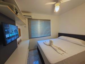 a bedroom with a bed with a towel on it at House in Yolanda Village in Foz do Iguaçu