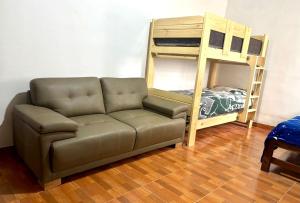a living room with a couch and a bunk bed at Dionny's House in Tinco +14 photos