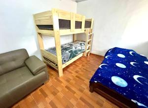 a living room with a bunk bed and a couch at Dionny's House in Tinco
