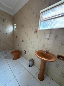 a bathroom with a sink and a toilet at Hotel Samaritano in Montes Claros