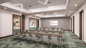 a conference room with a long table and chairs at Apiary Hotel Belleview Station Denver in Denver