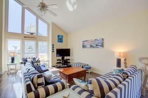 a large living room with couches and a tv at NTBHC636 Whale Den in North Topsail Beach