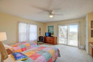a bedroom with two beds and a ceiling fan at NTBHC636 Whale Den in North Topsail Beach +23 photos