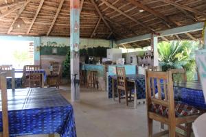 a restaurant with tables and chairs in a room at Campement Emanaye in Oussouye +67 photos