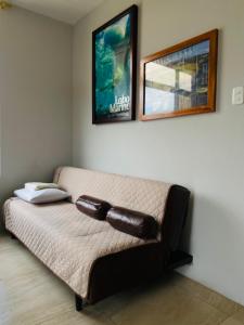 a couch in a living room with a picture on the wall at Suite Raya in Puerto Ayora +8 photos