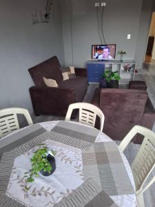 a table and chairs in a living room with a couch at Lily's Apartamentos in Cochabamba