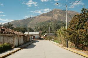 a street in a village with mountains in the background at Dionny's House in Tinco