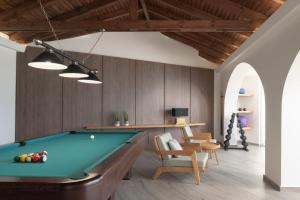 a living room with a pool table and chairs at Villa Kalliston - 4000m2 of Elevated Living in Rethymno