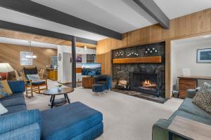 a living room with a couch and a fireplace at Meadow House 70 - Meredith Lodging in Sunriver