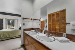 a bathroom with two sinks and a large mirror at Meadow House 70 - Meredith Lodging in Sunriver +81 photos