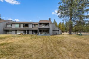 an image of a large house with a yard at Meadow House 70 - Meredith Lodging in Sunriver