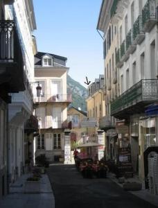 an empty street in a city with buildings at Super central studio in Cauterets