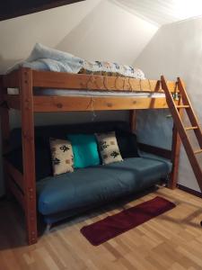a bunk bed with a couch under a bunk bed at Super central studio in Cauterets