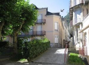 a building with a bird flying over a street at Super central studio in Cauterets +2 photos