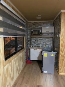 a kitchen with a sink and a counter in a room at Departamentos NAYISI in Puerto Natales