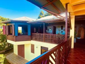 a balcony of a house with a porch at Hummingbird House in Calibishie