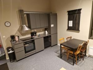 a kitchen with a table and a table and chairs at Skaland panorama in Senja +4 photos