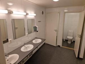 a bathroom with two sinks and a toilet at Skaland panorama in Senja