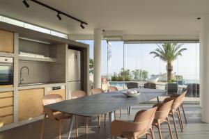 a kitchen and dining room with a table and chairs at Villa Kalliston - 4000m2 of Elevated Living in Rethymno