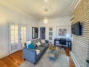 a living room with a couch and a tv at Cozy 1Bed, 1Bath in Brookline, MBTA in Brookline