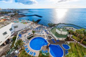 an aerial view of a resort with a pool and the ocean at Club Villamar Exclusive Beachfront Penthouse in Adeje