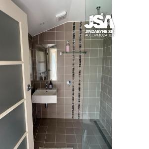 a bathroom with a shower and a sink at Kalkite Cottage in Kalkite +9 photos