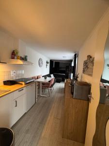 a kitchen and living room with a table and chairs at La Luna - Danny in Heerhugowaard