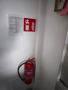 a fire hydrant in a white wall with a sign at Modern Lux studio in Beringen