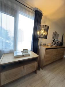 a kitchen with a table and a window with a book on it at La Luna - Danny in Heerhugowaard