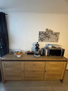 a counter with a microwave and a bowl of fruit on it at La Luna - Danny in Heerhugowaard