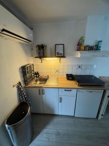 a small kitchen with a sink and a counter at La Luna - Danny in Heerhugowaard