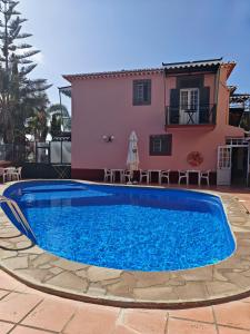 a villa with a swimming pool in front of a house at A Casa Do Caseiro in Funchal