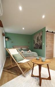 a bedroom with a bed and a table in it at La suite canopée en Brocéliande in Campénéac