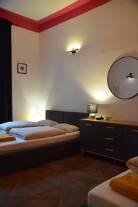 a bedroom with two beds and a mirror on the wall at Apartment Tomasza 8 in Krakow