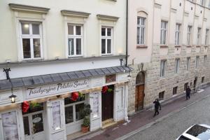 a building on a street with people walking in front of it at Apartment Tomasza 8 in Krakow
