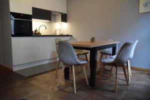 a kitchen with a table and chairs in a room at Apartment Tomasza 8 in Krakow +9 photos