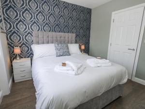 a bedroom with a large bed with towels on it at Vista Mare 2 in Weymouth