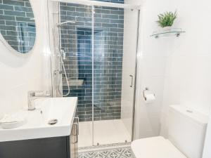 a bathroom with a shower and a toilet and a sink at Vista Mare 2 in Weymouth +17 photos