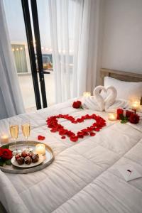 a bed with a heart made out of roses and candles at Deem view in Al Ain +35 photos