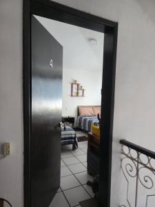 a door leading into a room with a bed at Cómoda habitación Mar in Veracruz