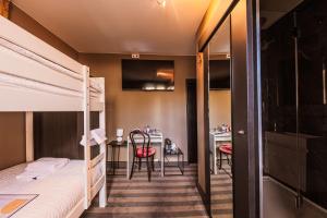 a room with two bunk beds and a table and a desk at Le Palmarès Spa in Spa
