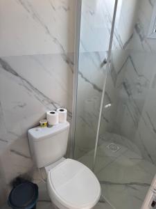 a white bathroom with a toilet and a shower at Apartamento com Custo Benefício Imbatível in Passo Fundo